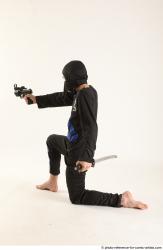 Man Young Athletic Fighting with gun Kneeling poses Casual Asian